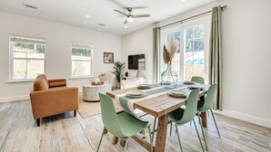 A dining area with a wooden table, green chairs, and a ceiling fan. - St Augustine Home < 3 Mi to Historic District! (St. Augustine)