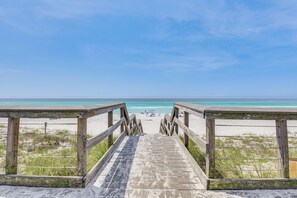 A wooden boardwalk leading to a beach with clear skies. - Miramar Beach Condo w/ Golf Course Views! (Miramar Beach)