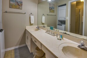 A bathroom with two sinks, a large mirror, and a towel rack. - Miramar Beach Rental w/ Pool Access & Golf Course! (Miramar Beach)