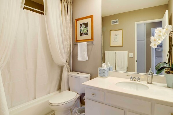 A bathroom with a toilet, sink, and shower curtain. - 2 Mi to Indian Wells: Palm Desert Home w/ Fire Pit (Palm Desert)