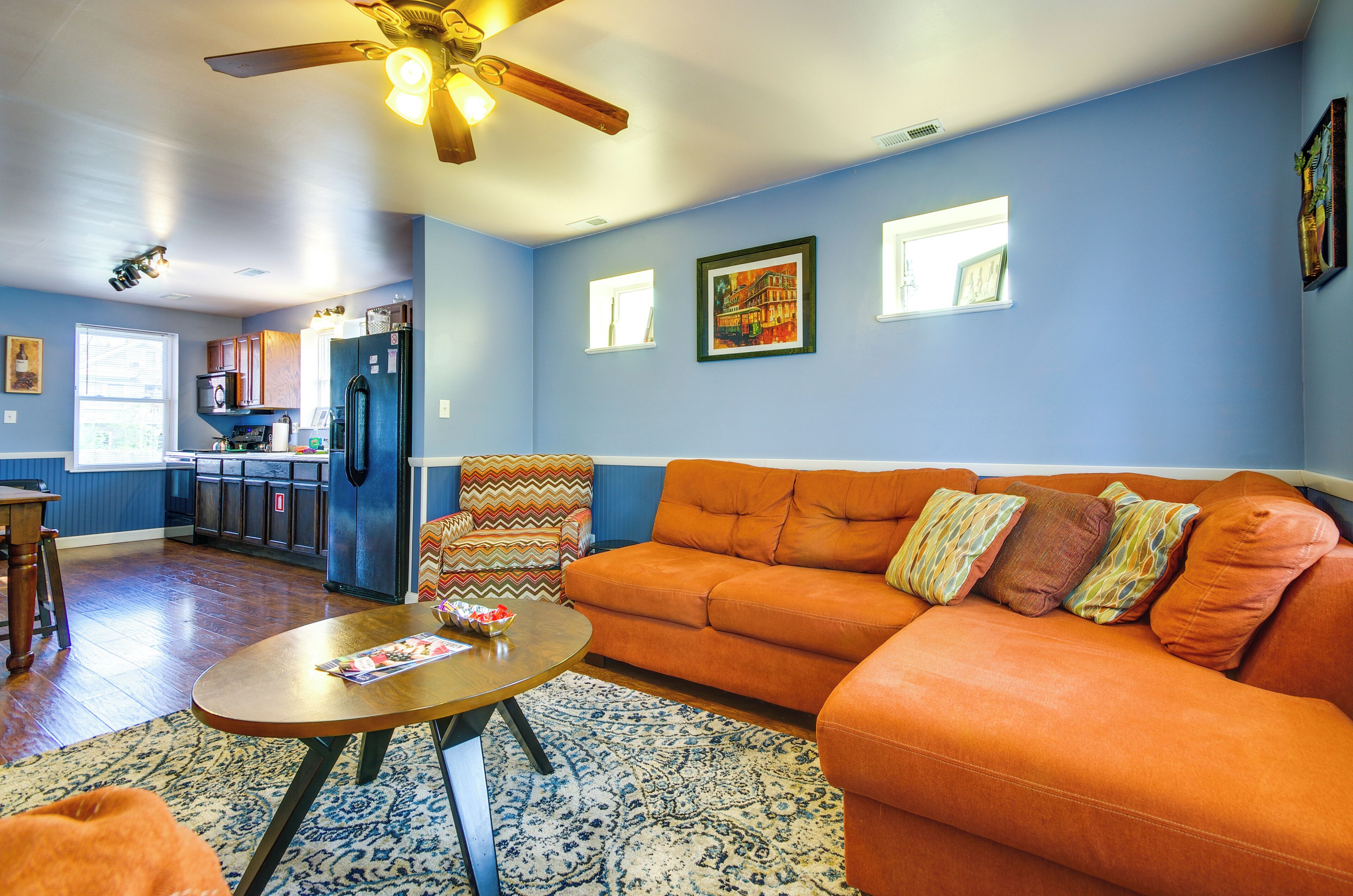 A living room with a sofa, a coffee table, and a patterned rug.