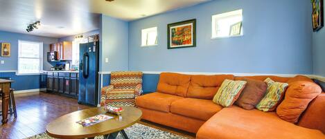A living room with a sofa, a coffee table, and a patterned rug.