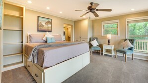 A bedroom with a bed, a chair, a nightstand, a ceiling fan, and a window. - Eagle Rock Gem on Table Rock Lake w/ Decks & Grill (Eagle Rock)