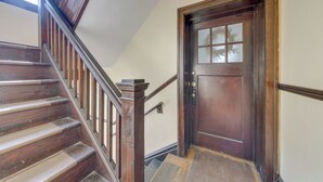 A wooden staircase with a handrail and a door with a window. - Inviting St Louis Apartment - Great Location! (St. Louis)
