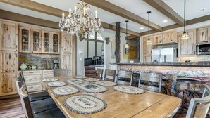 A spacious kitchen with wooden cabinets, a large island, and a chandelier. - Hot Tub Relaxation: Luxe Summit Gem w/ Mtn Views (Dillon)
