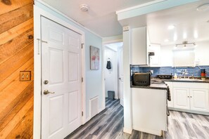 A kitchen with white cabinets, a microwave, and a toaster. - 3 Mi to Beach: Remodeled Seminole Apt w/ Yard! (Seminole)