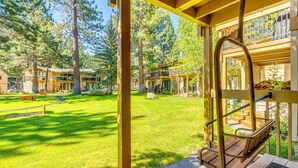 A resort with outdoor wooden structures, a grassy lawn, and multiple buildings with balconies. - Mammoth Lakes Vacation Rental: 1 Mi to Ski Area! (Mammoth Lakes)