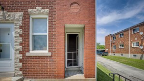 A red brick building with a white door and a small window. - Walk to Restaurants: Cozy, Convenient Jennings Apt (Jennings)