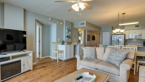 A living room with a television, sofa, and coffee table. - Fort Walton Beach Rental w/ Pool & Hot Tub Access (Fort Walton Beach)