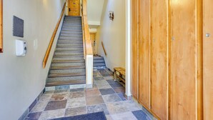 A staircase with a wooden handrail, a bench, and a wall-mounted light fixture. - 1 Mi to Keystone Resort: Mtn-view Family Escape! (Keystone)
