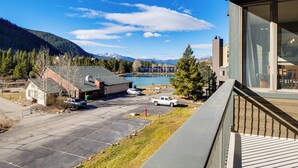 A residential area with a view of mountains and a lake. There are houses, a parking lot, and a wooden deck. - 1 Mi to Keystone Resort: Mtn-view Family Escape! (Keystone)