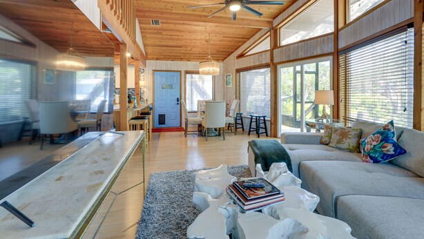 A spacious living area with a high ceiling, wooden beams, and large windows. - Scenic Siesta Key Home ~ 1 Mi to Village & Beach! (Siesta Key)