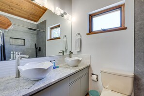 A modern bathroom with a large white sink, a toilet, and a shower area. - Scenic Siesta Key Home ~ 1 Mi to Village & Beach! (Siesta Key)