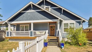 A two-story house with a front porch, a small front yard, and a wooden fence. - Cheery Tacoma Vacation Rental: 7 Mi to Owen Beach! (Tacoma)