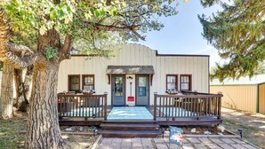 A building with a wooden deck, a front door, and a small porch area. - Cottage w/ Furnished Deck: 1 Mi to Dtwn Craig! (Craig)