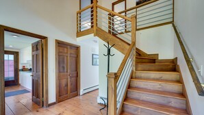 A wooden staircase with a glass railing leading to an upper floor. - Mendon Home w/ Hot Tub, Fire Pit & Near Skiing! (Rutland)