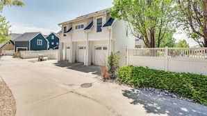 A residential building with a garage, a small garden, and a white picket fence. - 14 Mi to Dtwn Denver: Sleek Westminster Home (Westminster)