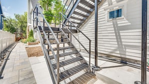 A modern building with a metal staircase leading to a second floor. - 14 Mi to Dtwn Denver: Sleek Westminster Home (Westminster)