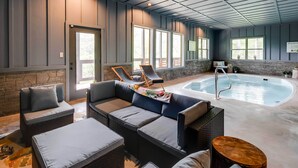 A poolside area with seating and a hot tub. - Cobbly Nob Resort Cabin: Hot Tub, Pool & Views! (Gatlinburg)