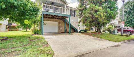 A two-story house with a covered garage and a front porch.