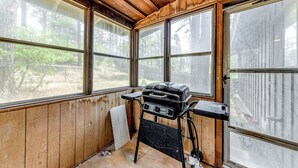 A wooden room with large windows, a barbecue grill, and a white towel hanging on the wall. - Serene Ruidoso Cabin w/ Fenced Yard Near Downtown! (Ruidoso)