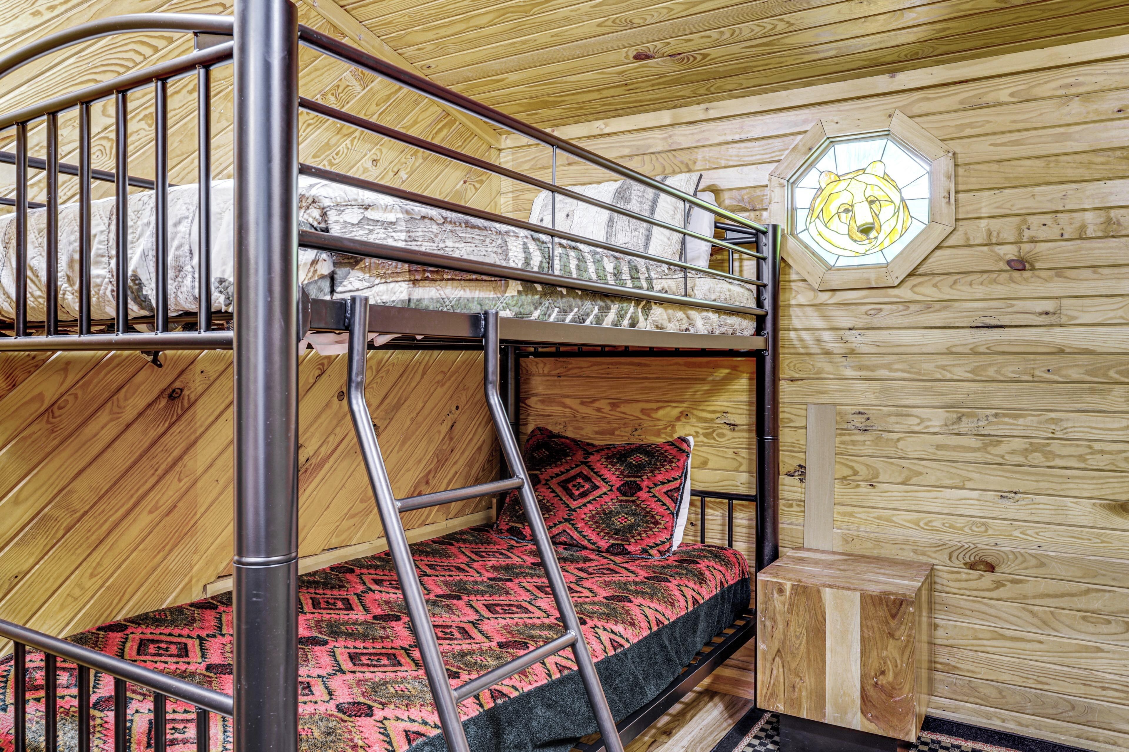 A bunk bed with a ladder, a patterned pillow, and a wooden headboard.