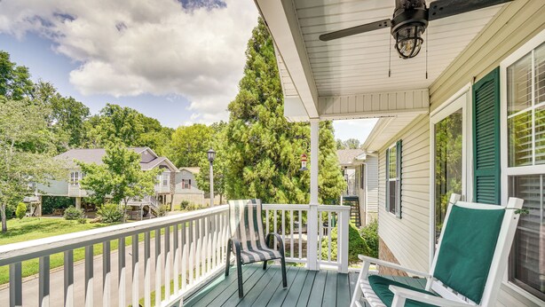 A porch with white railings, a ceiling fan, and two rocking chairs with green cushions. - Pigeon Forge Home w/ Deck & Hot Tub Near Town! (Pigeon Forge)