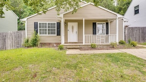 A single-story house with a front porch, a small front yard, and a wooden fence. - 2 Mi to Dtwn Durham: Home Near Universities (Durham)