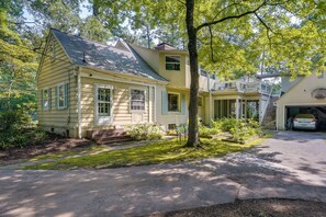 A two-story house with a front yard, a driveway, and a garage. - Spacious Durham Apartment Near Downtown (Durham)