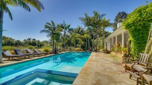 A swimming pool with lounge chairs and potted plants. - Farmhouse-chic Carpinteria Cottage w/ Pool Access (Carpinteria)