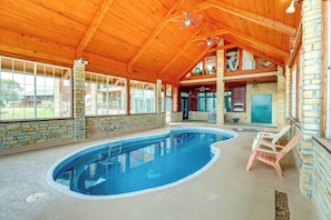 An indoor swimming pool with a wooden ceiling and stone walls, surrounded by lounge chairs. - Hike & Fish: Studio w/ Pool Access in Shirley! (Shirley)