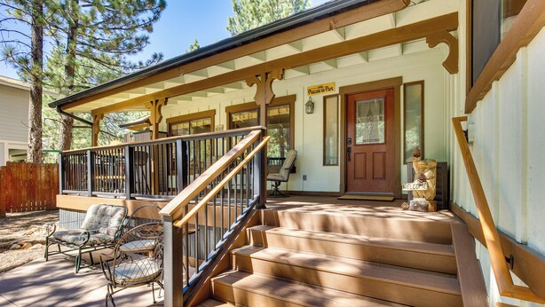 A wooden staircase leading to a porch with a 'Welcome' sign, outdoor seating, and a 'Passage to Park' sign. - Central Big Bear Lake Retreat w/ Private Hot Tub! (Big Bear Lake)