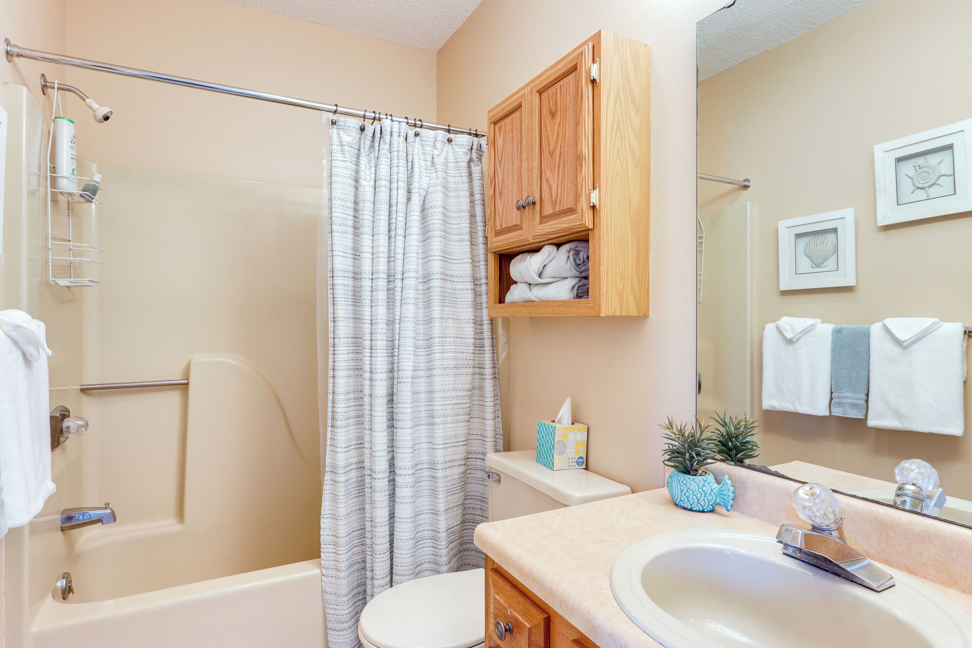 A bathroom with a bathtub, toilet, and sink.