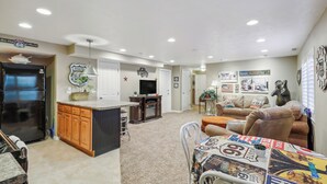 A spacious living area with a kitchen, a dining table, and a sofa.