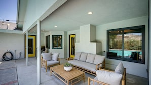A covered outdoor seating area with a sofa, chairs, and a coffee table. - Bakersfield Oasis: Private Pool, Hot Tub & Patio! (Bakersfield)