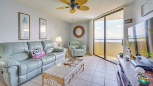 A living room with a sofa, armchair, coffee table, and a ceiling fan. - Pool & Beach Access: Waterfront Hudson Condo! (Hudson)