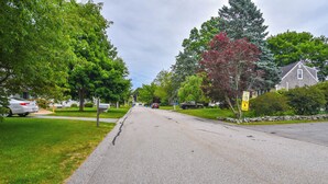 A residential street lined with trees and houses. - Middletown Vacation Rental: 2 Mi to Beach! (Middletown)