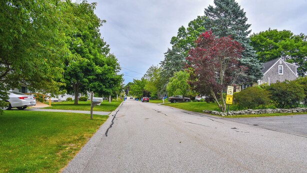 A residential street lined with trees and houses. - Middletown Vacation Rental: 2 Mi to Beach! (Middletown)