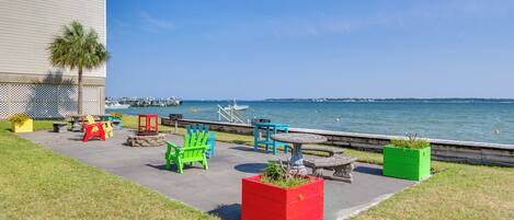 A patio area with outdoor seating and a view of the water.