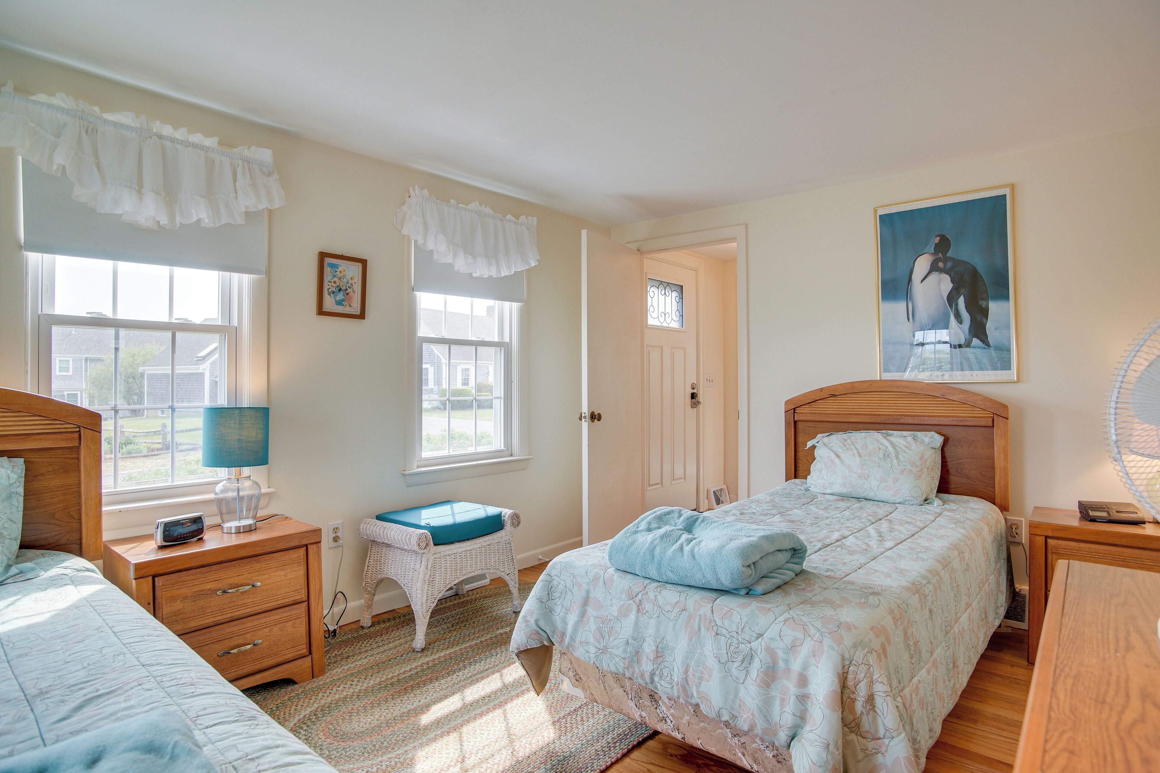 A bedroom with a bed, bedside tables, a chair, and a window.