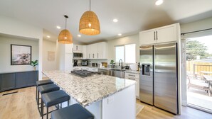 A modern kitchen with a large island, stainless steel appliances, and pendant lighting. - Pet-friendly Monterey Home 2 Mi to Beach (Monterey)