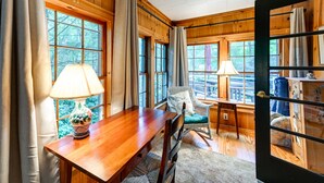 A wooden dining area with a table, chairs, and a lamp. - Highlands Vacation Rental - Walk to Mirror Lake! (Highlands)