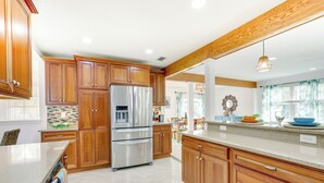 A kitchen with wooden cabinets, stainless steel appliances, and a large island. - St Augustine Home Near Vilano Beach: Pets Welcome! (St. Augustine)