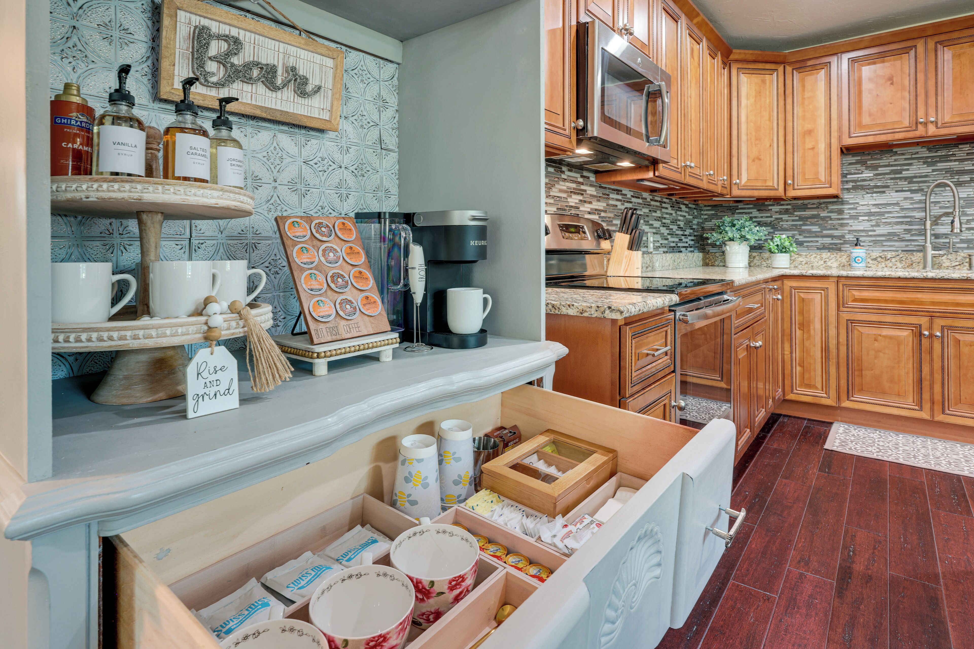 A kitchen with wooden cabinets, a coffee machine, and a variety of kitchenware on the counter.