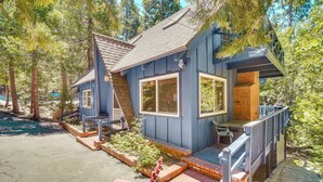 A small, two-story cabin with a porch and a deck, surrounded by trees. - Steps to Lake Arrowhead: Cabin w/ Full Lake Access (Lake Arrowhead)