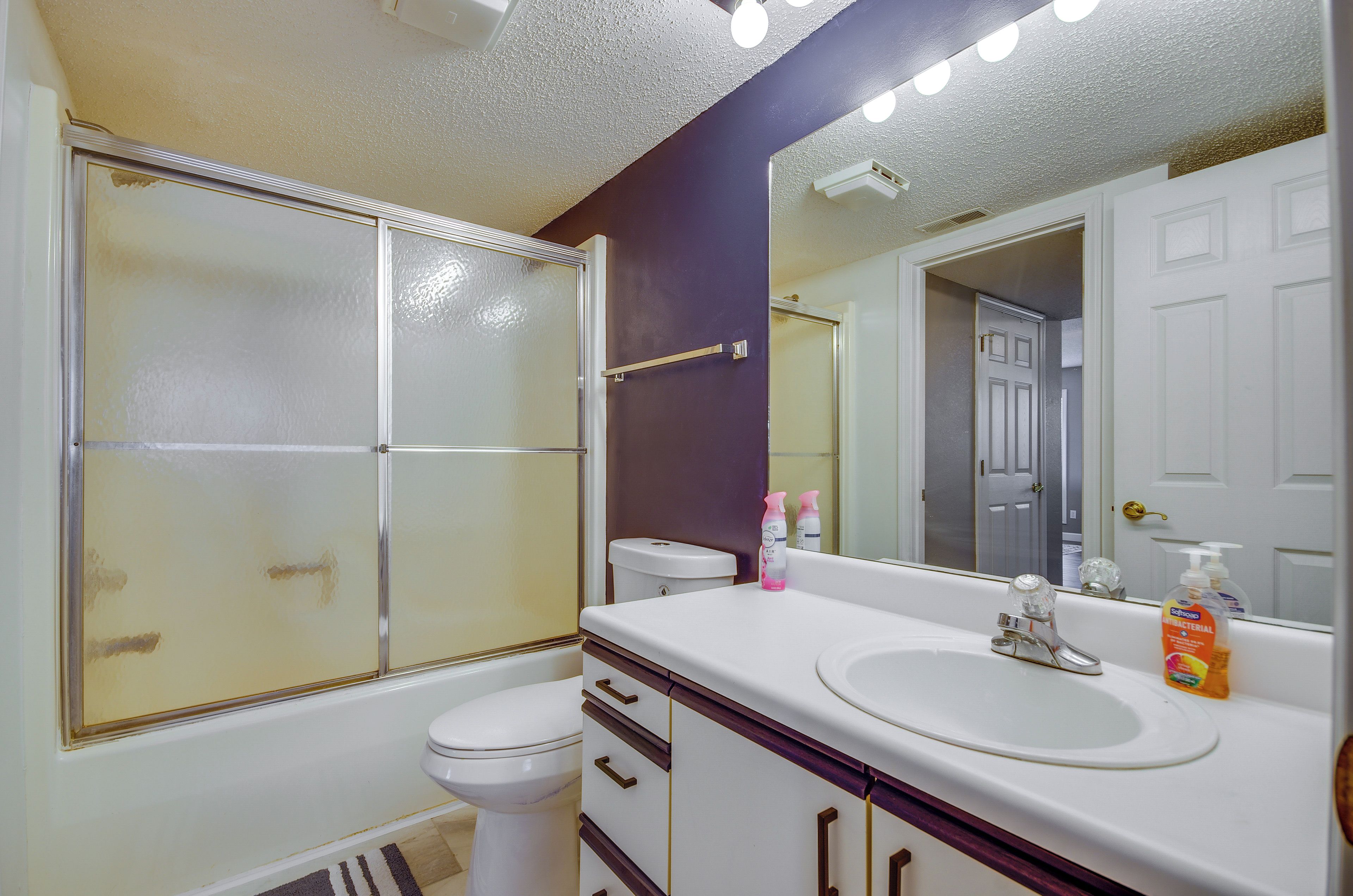 A bathroom with a toilet, a sink, and a shower.