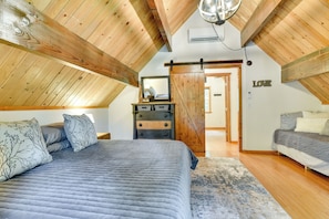 A bedroom with a large bed, a dresser, and a wardrobe.