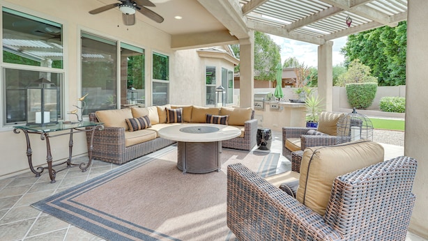 A covered patio area with wicker furniture, a glass table, and a ceiling fan. - Retreat w/ Outdoor Oasis! Day Trip to Dtwn Phoenix (Peoria)