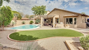 A backyard with a swimming pool, a patio area, and a lawn. - Retreat w/ Outdoor Oasis! Day Trip to Dtwn Phoenix (Peoria)