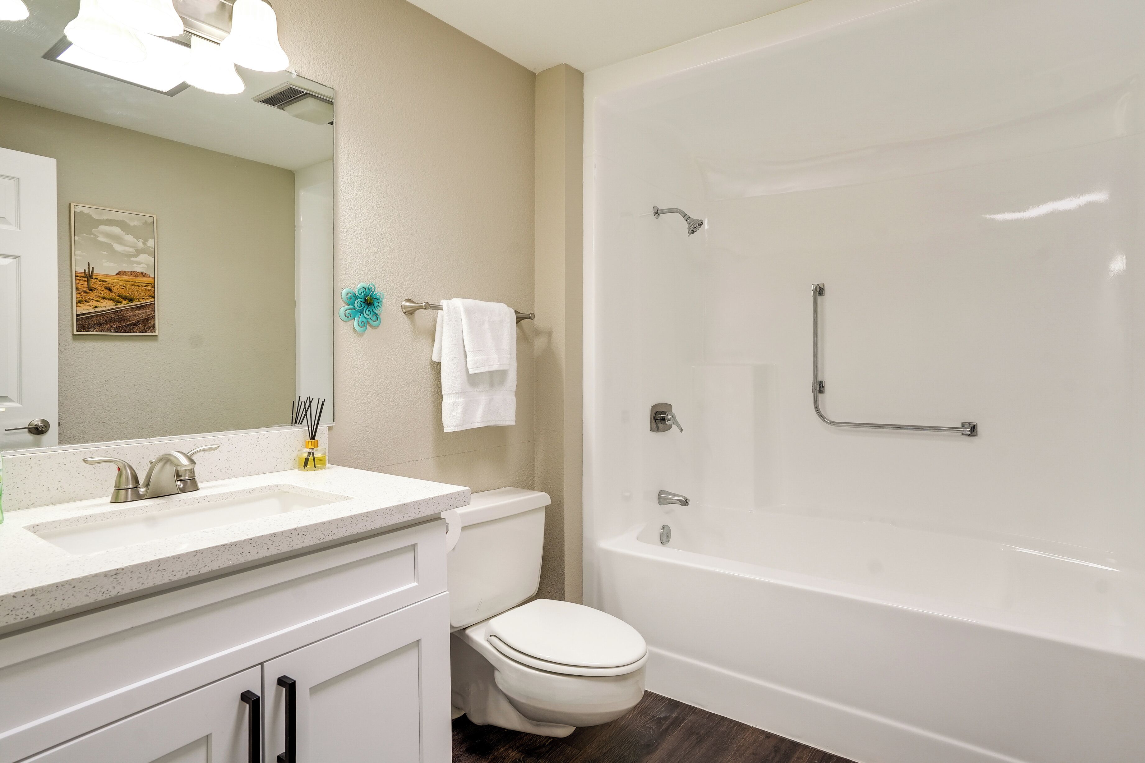 A bathroom with a white sink, toilet, and bathtub.